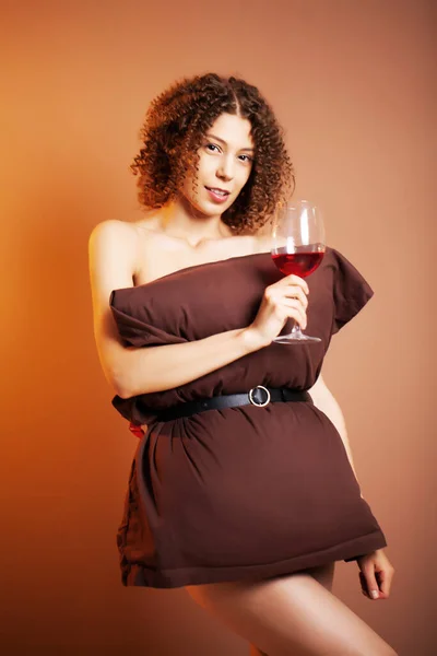 Cute woman with glass of red wine participate pillow challenge — Stock Photo, Image