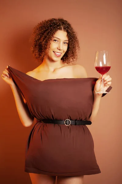 Cute woman with glass of red wine participate pillow challenge — Stock Photo, Image