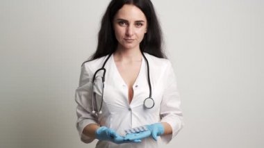 Eldivenli kadın doktor, erkeklerin cinsel sağlığı için ilaç tutuyor..