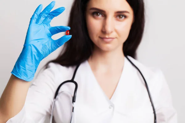 Conceito de medicina, médico feminino segurando pílulas prescritas para o tratamento do paciente — Fotografia de Stock