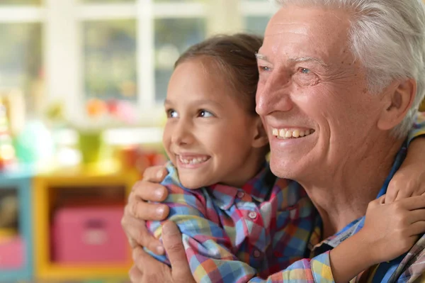 Grandfather and granddaughter hug — Stock Photo, Image