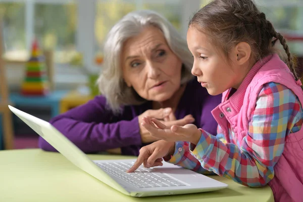 Mormor och barnbarn med bärbar dator — Stockfoto