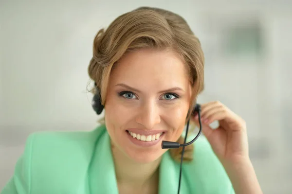 Young woman in headset — Stock Photo, Image