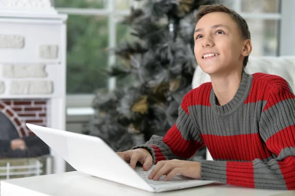 Smiling boy with laptop — Stock Photo, Image