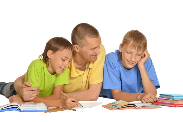 Father with sons doing homework — Stock Photo, Image