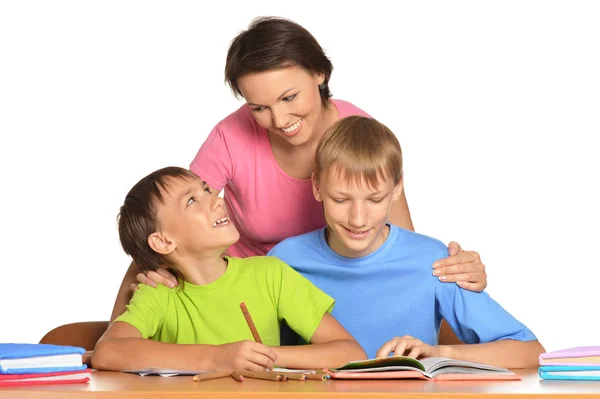 Mother with sons doing homework — Stock Photo, Image