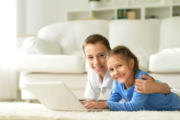 Hermano y hermana usando laptop — Foto de Stock