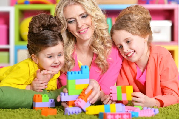 Young woman playing with daughters — Stock Photo, Image