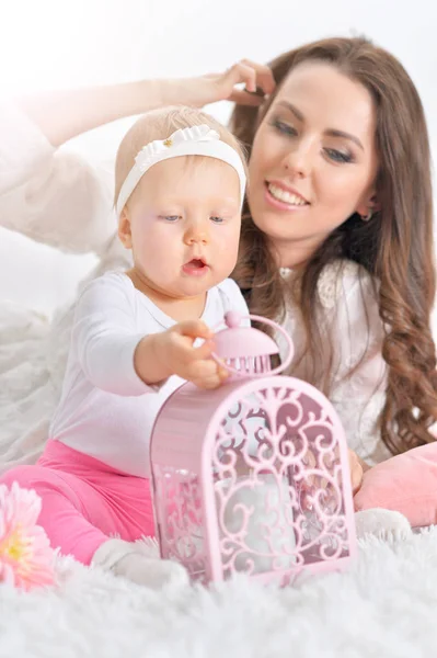 Young woman playing with little daughter — Stock Photo, Image