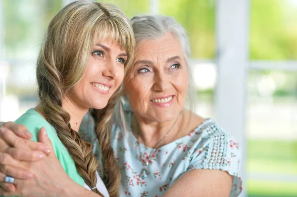 Beautiful young woman with mother — Stock Photo, Image