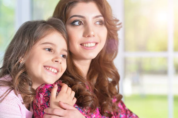 Young mother hugging little daughter — Stock Photo, Image