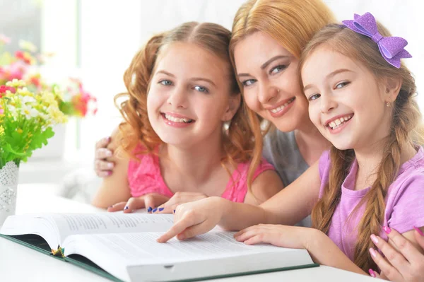 Mor med döttrar läsning — Stockfoto