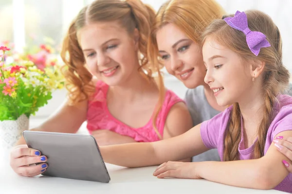 Woman and  girls using   tablet — Stock Photo, Image