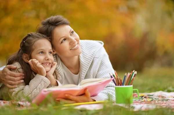 Girl with her grandmother reading — Stock Photo, Image