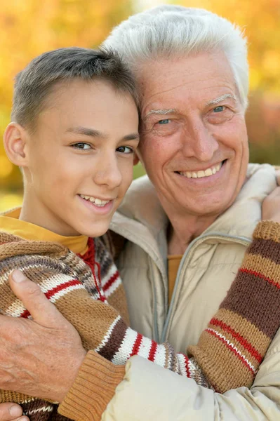 Grandfather and grandson hugging  in park — Stock Photo, Image