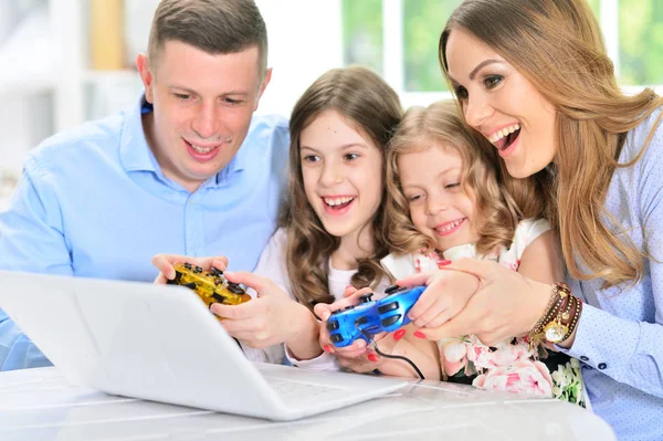 Famille jouant sur ordinateur portable à la table — Photo