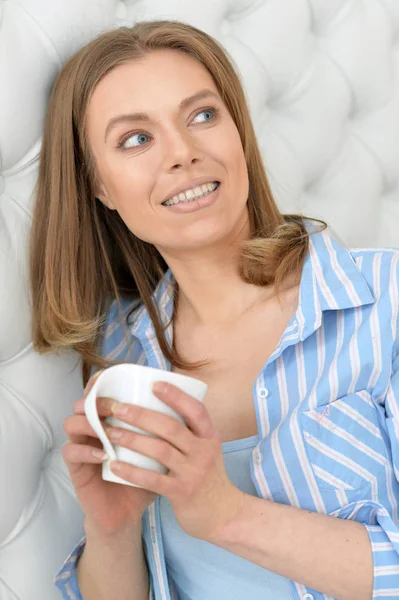 Beautiful young woman with white cup — Stock Photo, Image