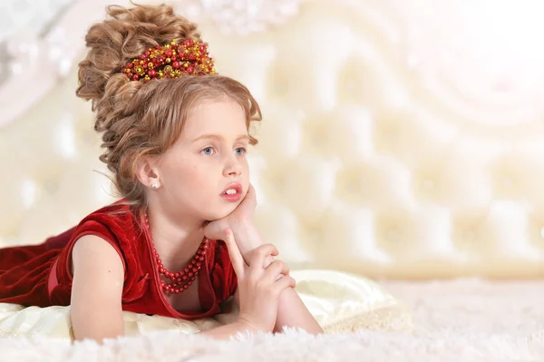 Little girl in red velvet dress — Stock Photo, Image