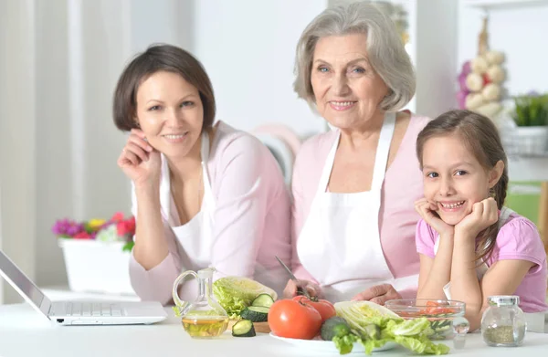 Mother, daughter and grandmother cooking together — Stock Photo, Image