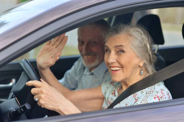 Senior couple driving car — Stock Photo, Image