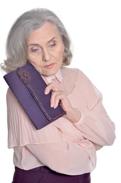 Sad senior woman with purple clutch — Stock Photo, Image
