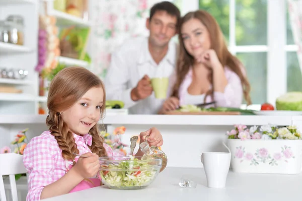 Cute little daughter preparing salad — Stock Photo, Image