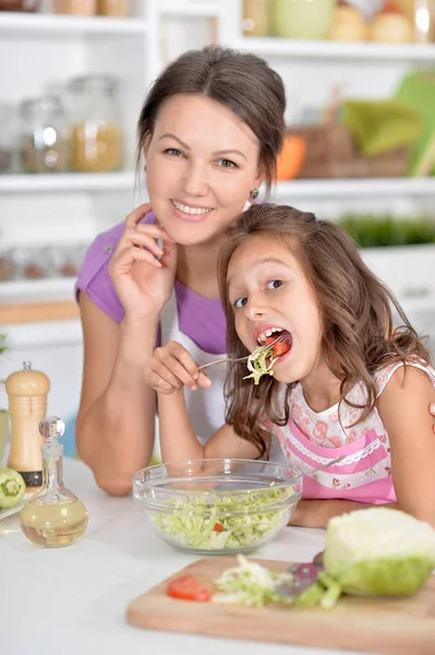 Little girl tasting salad — Stock Photo, Image