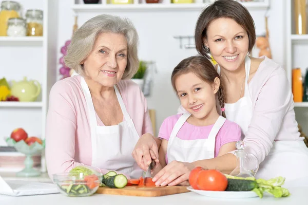 Mother, daughter and grandmother cooking together Stock Picture