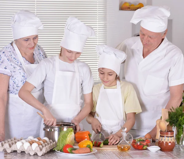 Großeltern mit Enkeln kochen zusammen — Stockfoto