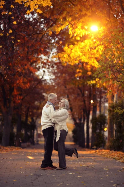 Elderly couple in autumnal forest — Stock Photo, Image