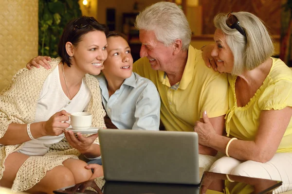 Family near table with laptop — Stock Photo, Image