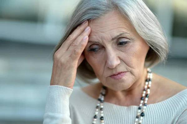 Senior woman with headache — Stock Photo, Image