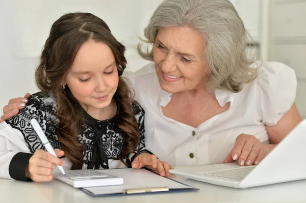祖母と孫娘が宿題をして — ストック写真