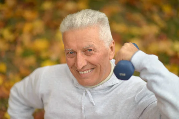 Senior man with dumbbell — Stock Photo, Image