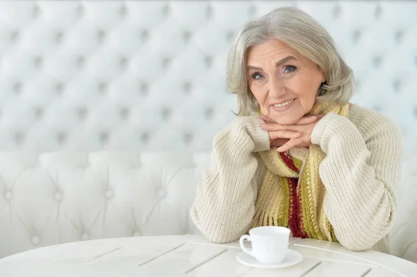 Femme à table avec tasse de thé — Photo