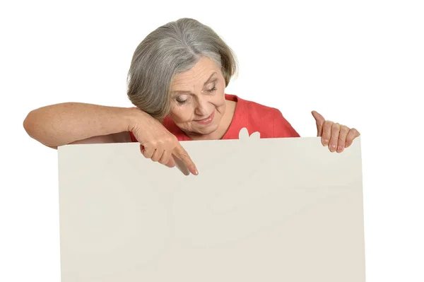 Elderly woman pointing to blank card — Stock Photo, Image