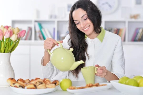 Frau schenkt Tee ein — Stockfoto