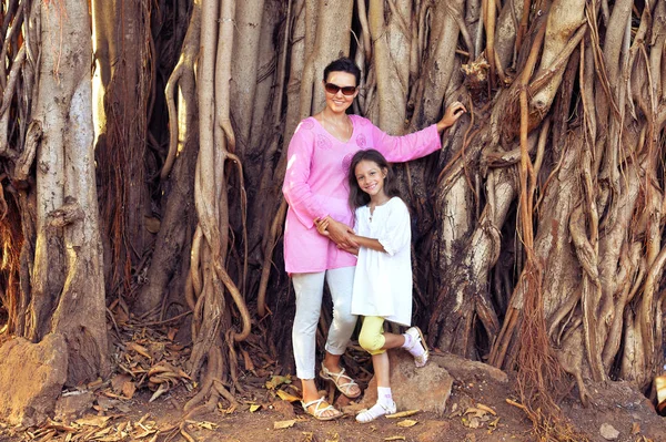 Mère et fille contre l'arbre exotique — Photo