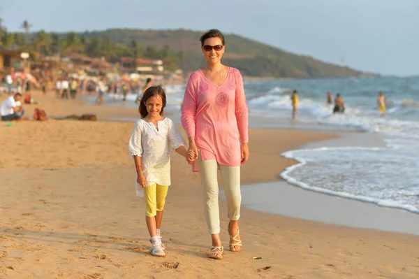 Mother and daughter on sandy beach — Stock Photo, Image