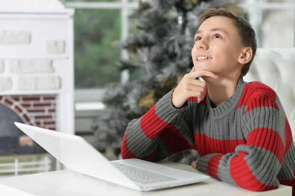 Thoughtful teen boy with laptop — Stock Photo, Image