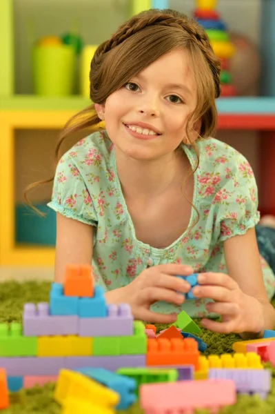 Girl with colorful plastic blocks — Stock Photo, Image