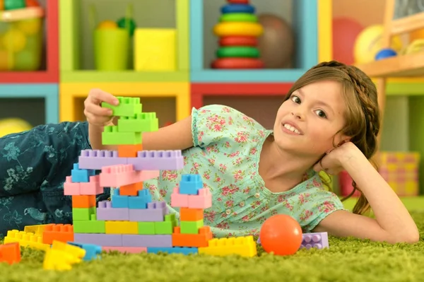Girl with colorful plastic blocks — Stock Photo, Image