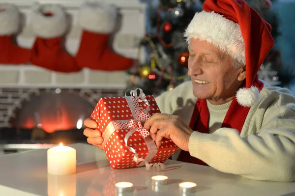Senior man with Christmas gift — Stock Photo, Image