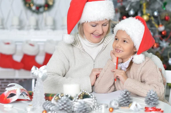 Flicka med mormor som förbereder sig för jul — Stockfoto