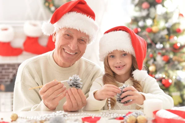 Dědeček a dítě v Santa klobouky — Stock fotografie