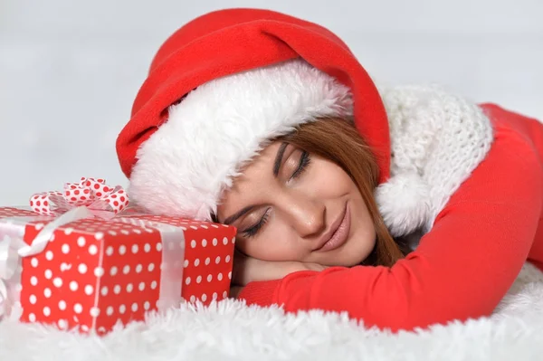 Woman with Christmas gift sleeping — Stock Photo, Image