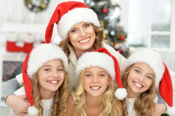 Little girls with mother in Santa hats — Stock Photo, Image