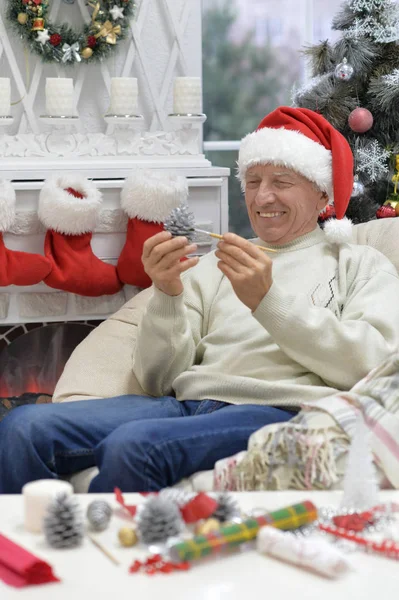 Smiling senior man in Christmas hat — Stock Photo, Image