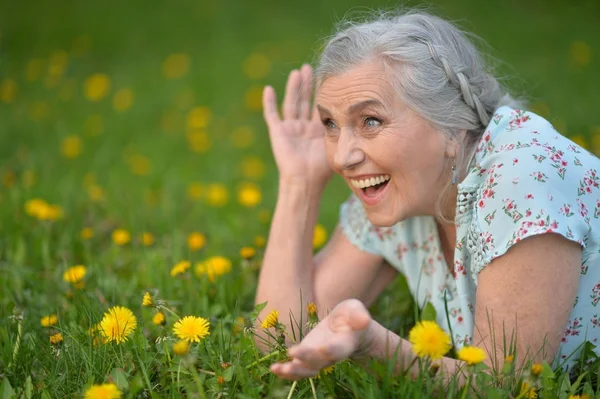 Elderly woman lying — Stock Photo, Image
