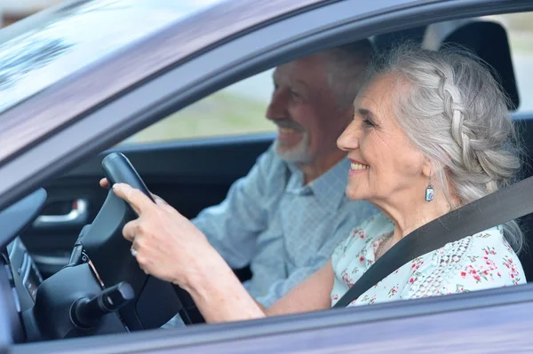 Senior couple driving car — Stock Photo, Image